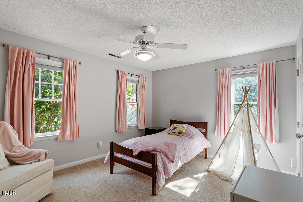 2108 Cedarbluff Court Raleigh, NC 27615 - Photo 22 of 38 a bedroom with a bed and wooden floor