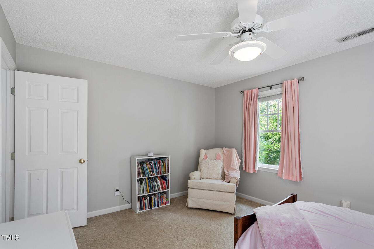 2108 Cedarbluff Court Raleigh, NC 27615 - Photo 25 of 38 a living room with furniture and a window