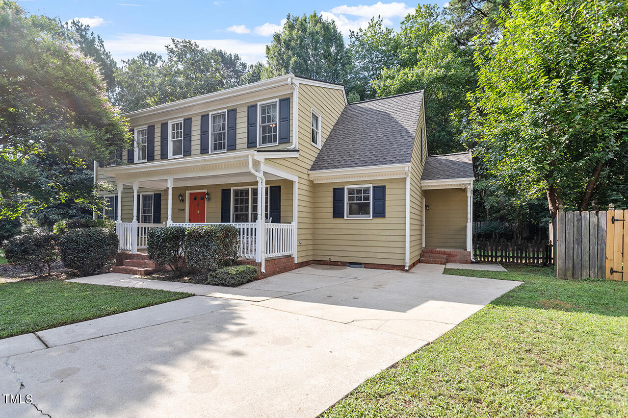 2108 Cedarbluff Court Raleigh, NC 27615 - Photo 36 of 38 a front view of a house with a yard and potted plants