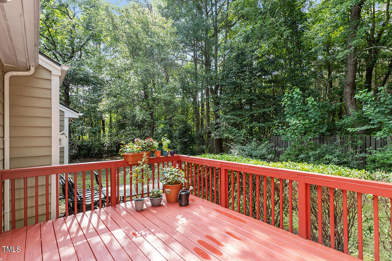 2108 Cedarbluff Court Raleigh, NC 27615 - Photo 4 of 38 a balcony with wooden floor and yard in the back