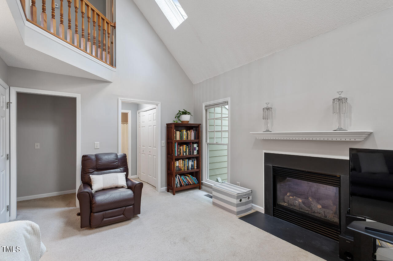 2108 Cedarbluff Court Raleigh, NC 27615 - Photo 6 of 38 a living room with furniture a fireplace and a book shelf