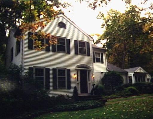 21 Memory Lane Ridgefield, CT 06877 - Photo 1 of 1 a front view of a house with a yard and garage