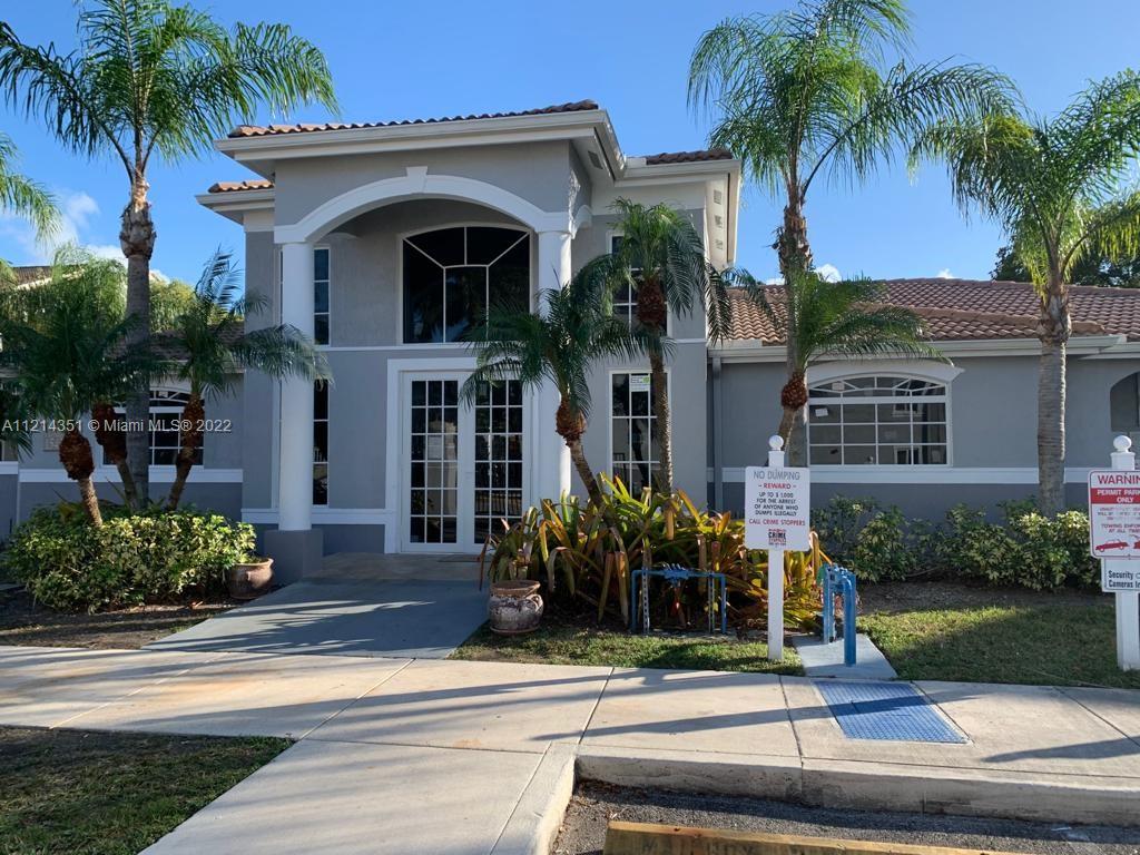 15422 Southwest 284th Street, Unit 7107 Homestead, FL 33033 - Photo 4 of 5 front view of house with a yard and palm trees