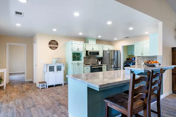 a kitchen with sink stove and cabinets