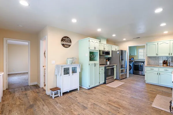 a kitchen with stainless steel appliances a stove a sink and a microwave