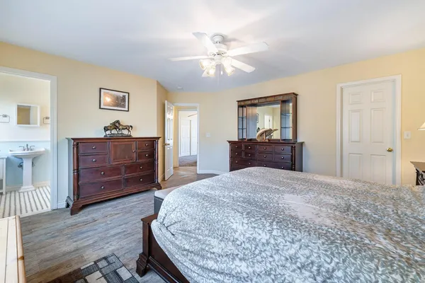 a white tub sitting next to a white cabinet