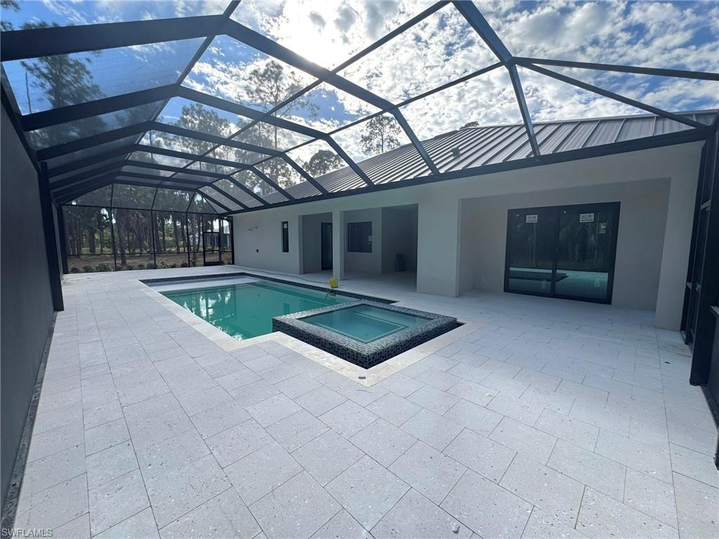 1618 19th Street Southwest Naples, FL 34117 - Photo 2 of 3 a living room with a lots of furniture and a chandelier