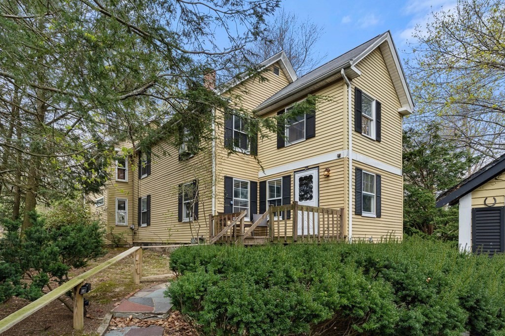 a front view of a house with trees