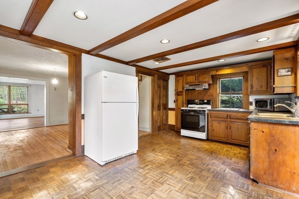 21 Columbus Street Lexington, MA 02421 - Photo 12 of 26 a kitchen with stainless steel appliances a refrigerator and a stove top oven