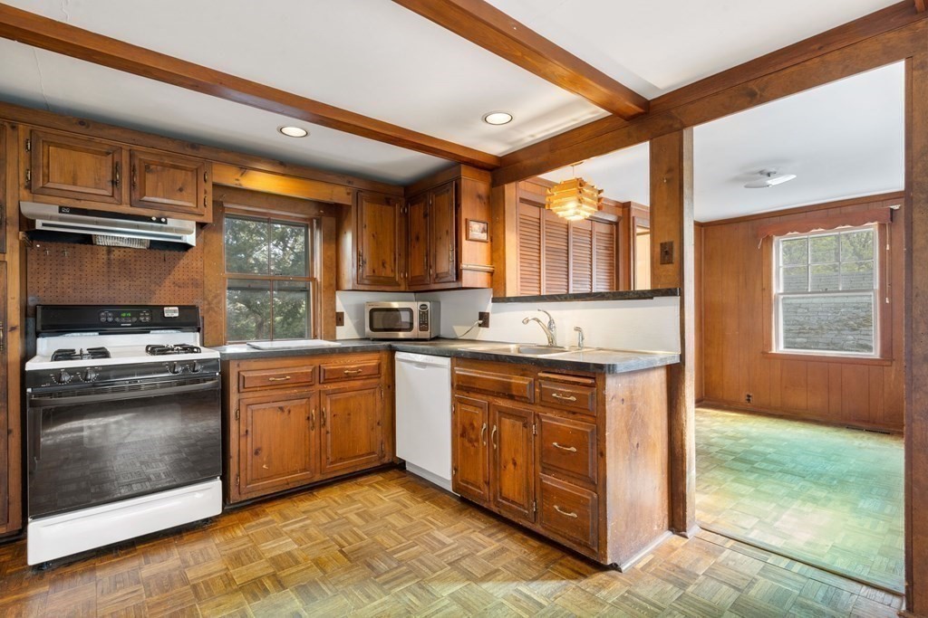 21 Columbus Street Lexington, MA 02421 - Photo 13 of 26 a kitchen with stainless steel appliances granite countertop a stove a sink and a microwave