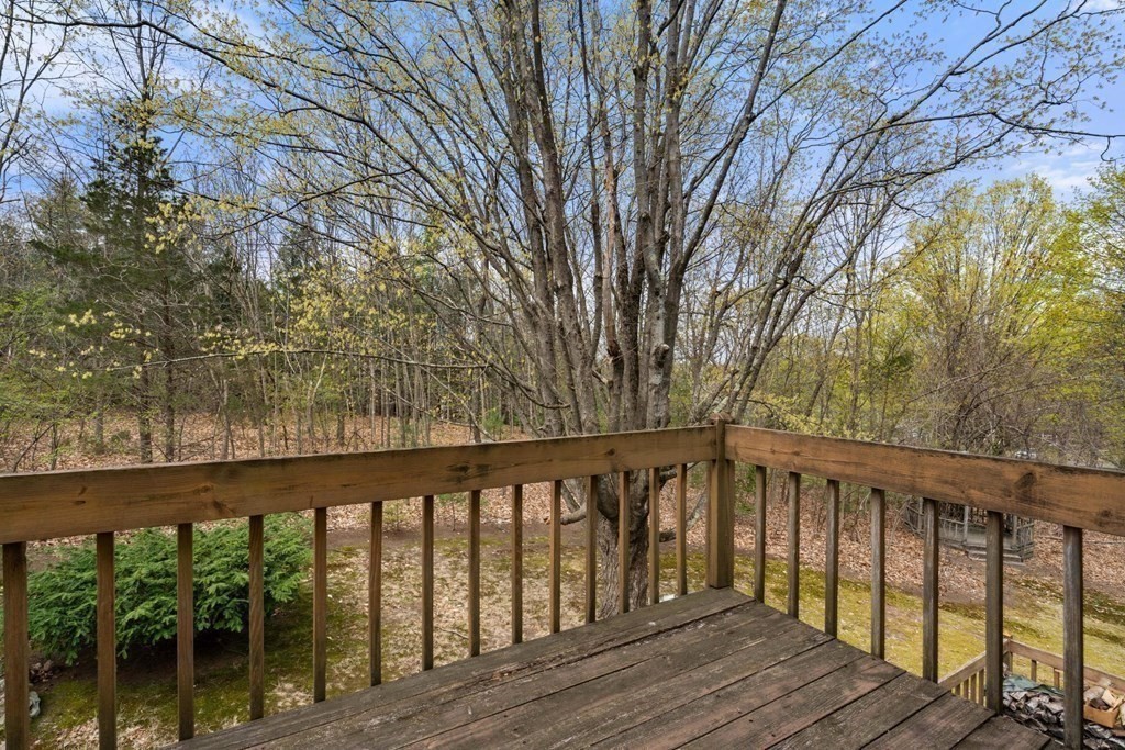 21 Columbus Street Lexington, MA 02421 - Photo 5 of 26 a balcony with wooden floor and fence