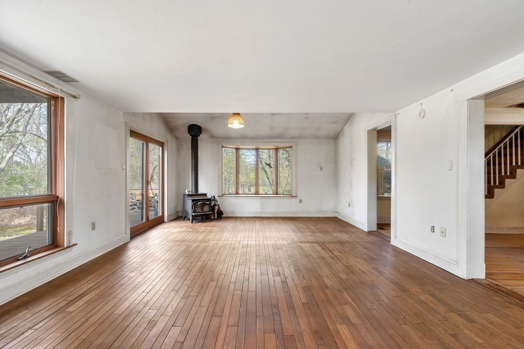 21 Columbus Street Lexington, MA 02421 - Photo 9 of 26 an empty room with wooden floor and windows