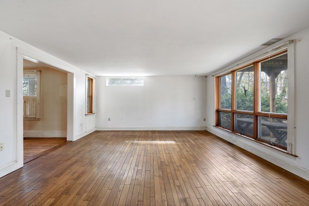 21 Columbus Street Lexington, MA 02421 - Photo 10 of 26 a view of an empty room with glass door and wooden floor