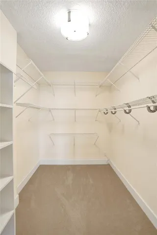 an empty room with closet and fan