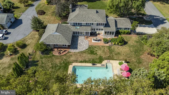 an aerial view of a house with pool