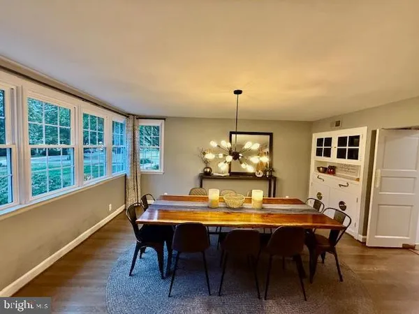 a large kitchen with a table and chairs