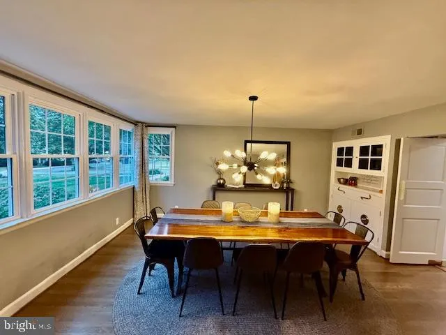 a large kitchen with a table and chairs