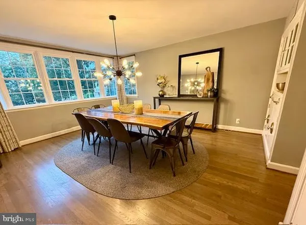 a view of kitchen with refrigerator and wooden floor