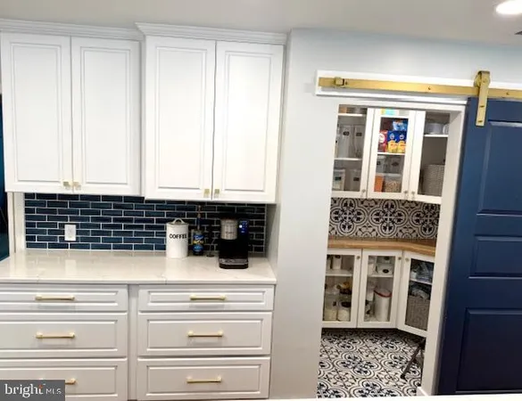 a kitchen with a sink a window and cabinets