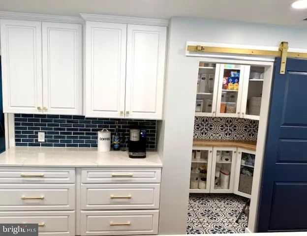 a kitchen with a sink a window and cabinets