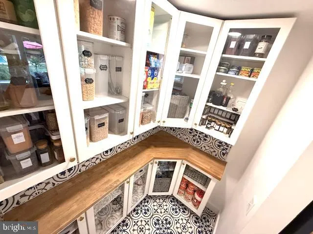 a spacious bedroom with a bed and wooden floor