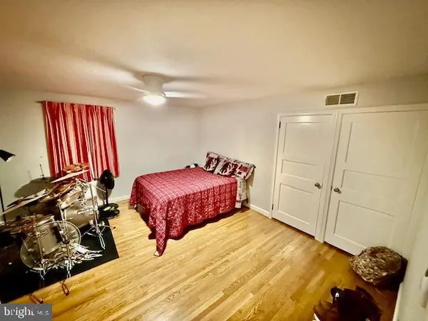 a spacious bathroom with a double vanity sink a mirror and a shower