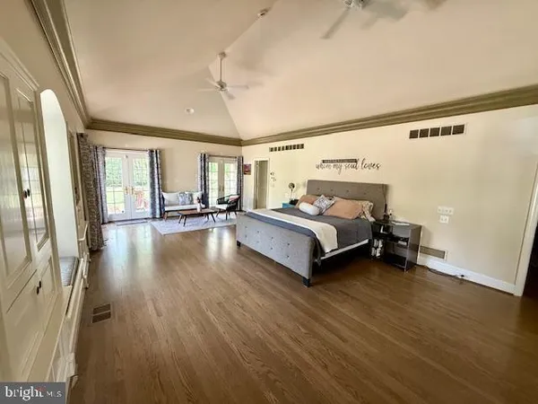 a bedroom with a bed and wooden floor