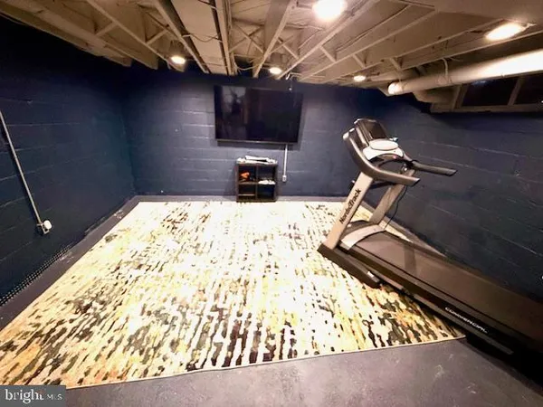 an aerial view of residential house with outdoor space and trees all around