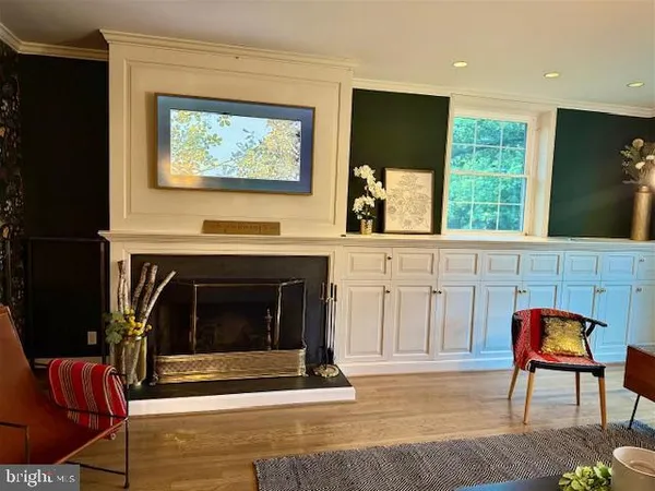 a dining room with furniture a chandelier and wooden floor