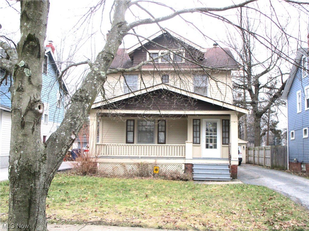 View of front facade featuring a front lawn and a porch