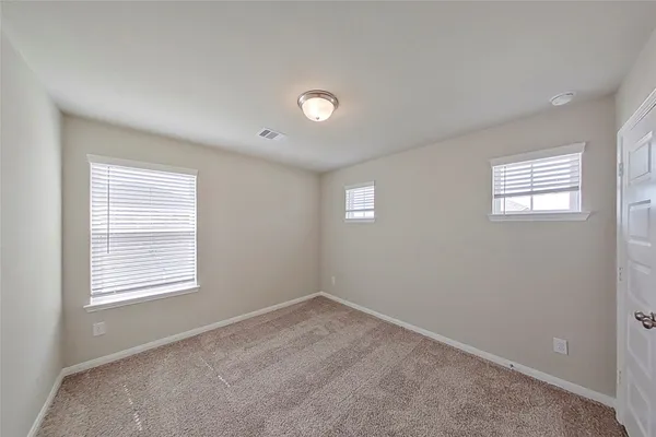 a view of an empty room and closet area