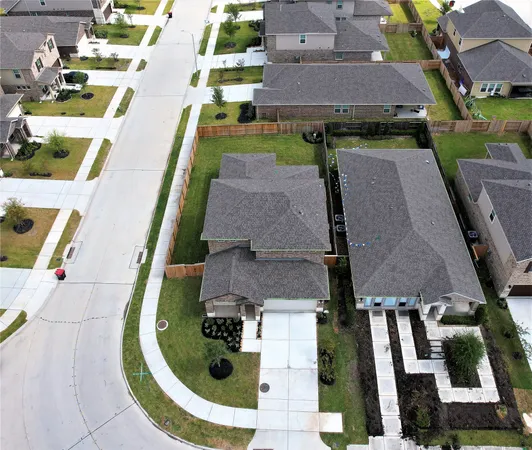 an aerial view of a house with a lake view