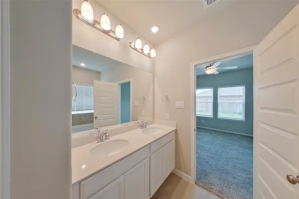 a bathroom with a double vanity sink a mirror and a shower