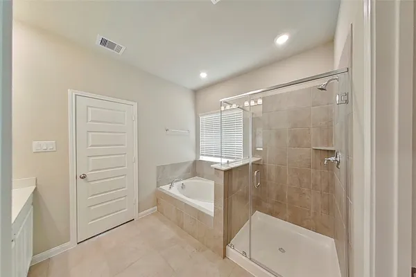 a bathroom with a tub and shower