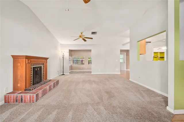 a view of empty room with a fireplace