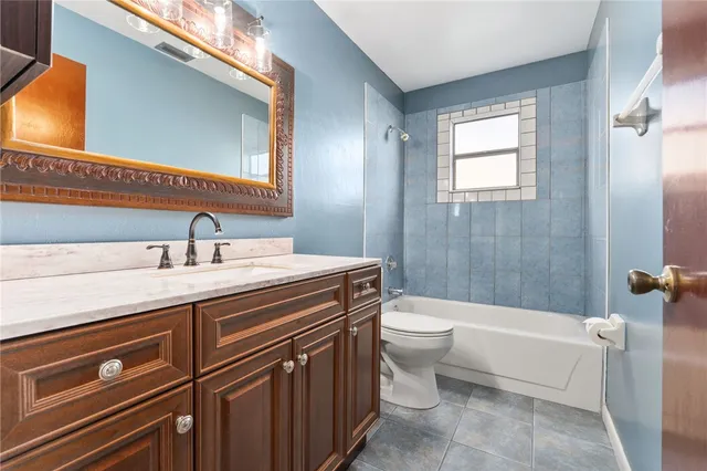 a bathroom with a double vanity sink toilet and shower