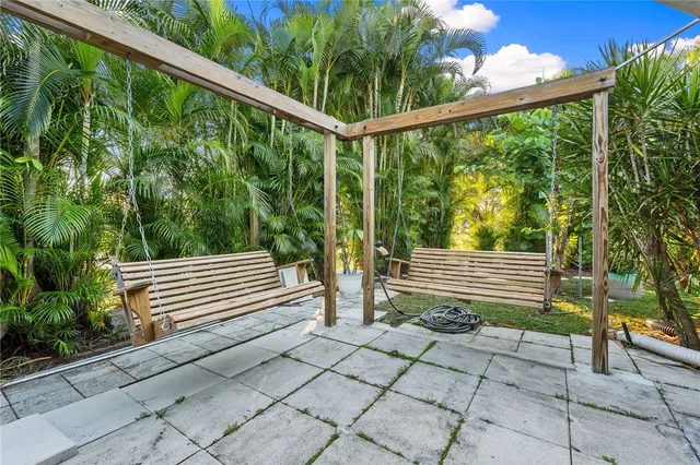 a green field covered with trees in the background