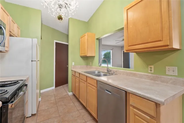 a kitchen with a sink and a refrigerator