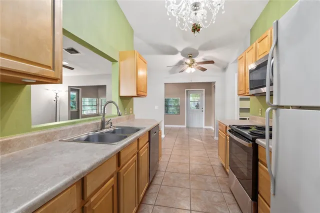 a kitchen with a sink refrigerator and cabinets