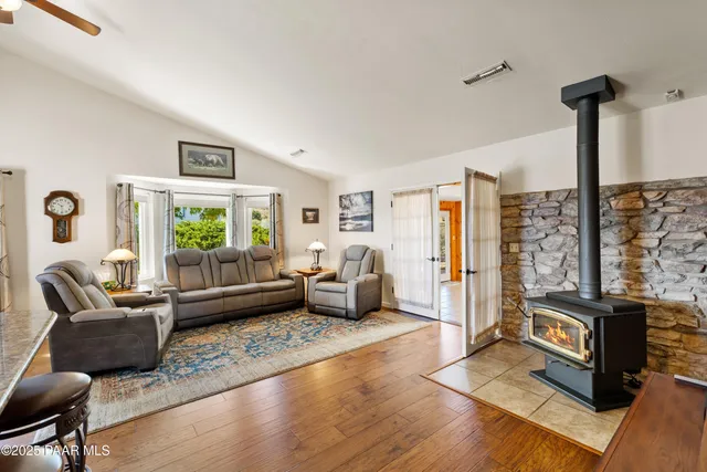a kitchen with kitchen island a stove a sink a counter space and dining table