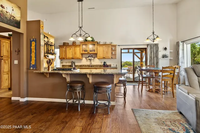 a kitchen with stainless steel appliances granite countertop a stove and cabinets
