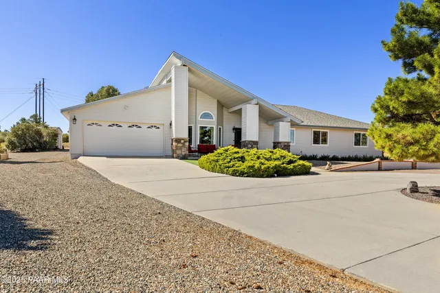 a front view of a house with a yard and a garage
