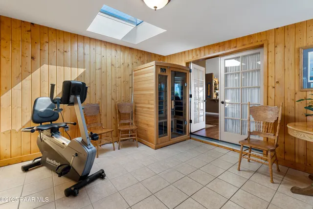 a spacious bedroom with a bed and a flat screen tv