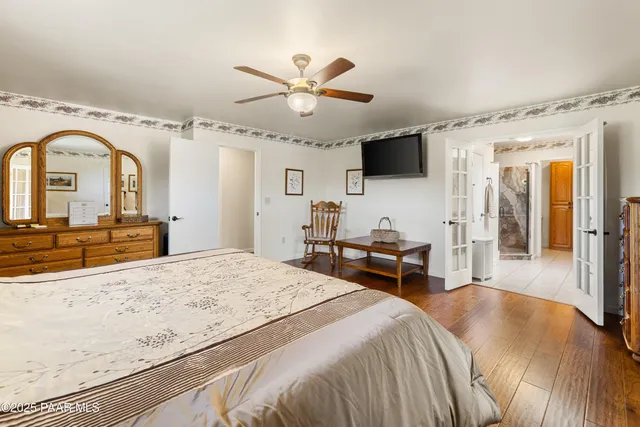 a living room with furniture and floor to ceiling windows