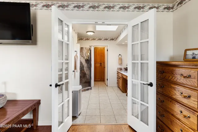 a bedroom with furniture and large windows