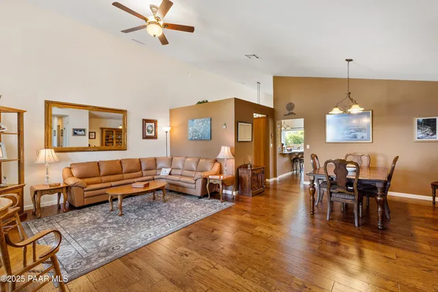 a living room with furniture wooden floor and a table