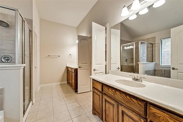 a spacious bathroom with a sink double vanity and a mirror