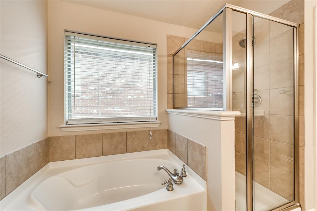 204 Dancing Light Lane Red Oak, TX 75154 - Photo 14 of 21 a bathroom with a bathtub and a shower