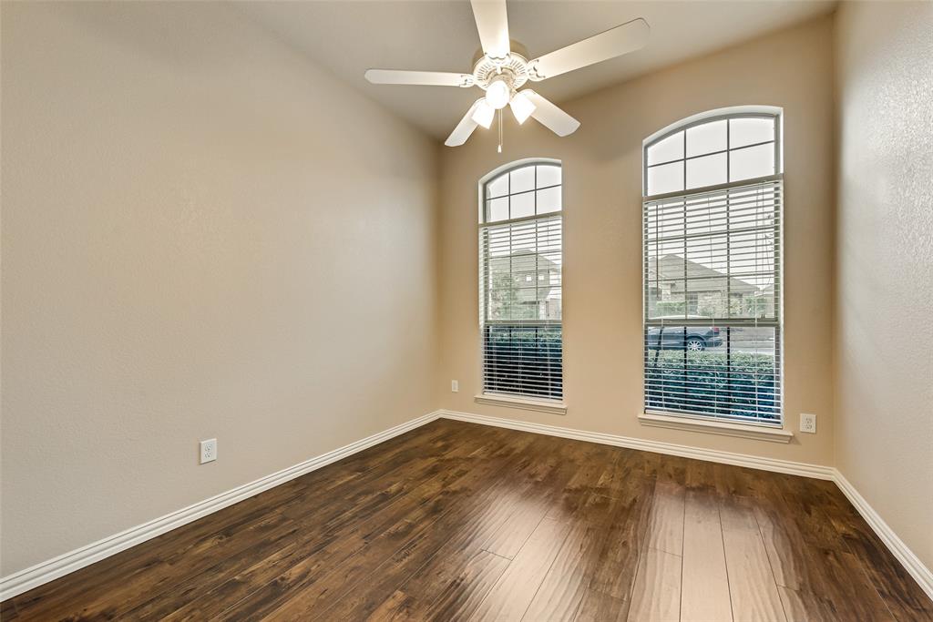 204 Dancing Light Lane Red Oak, TX 75154 - Photo 15 of 21 a view of an empty room with wooden floor and a window
