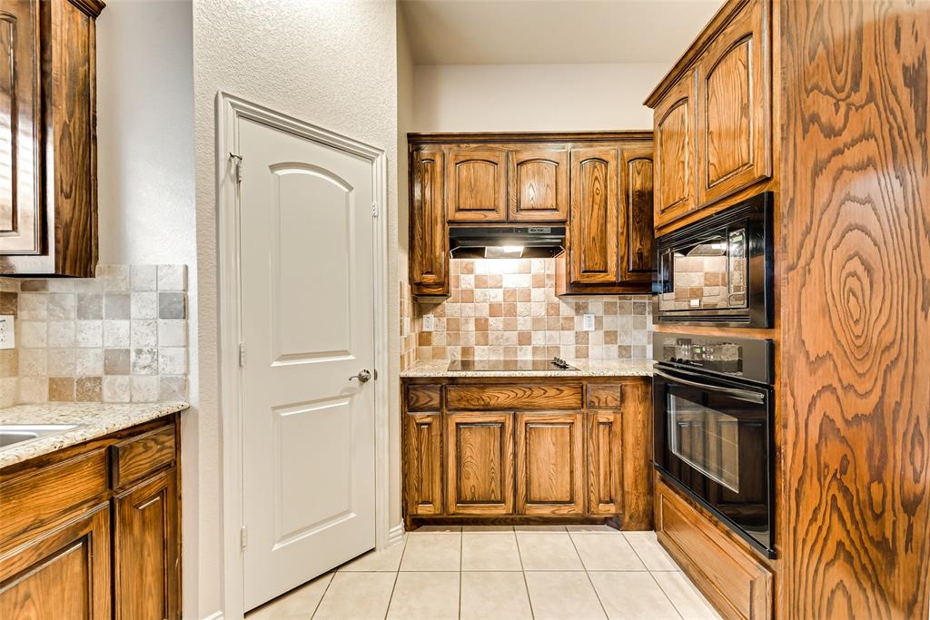 204 Dancing Light Lane Red Oak, TX 75154 - Photo 5 of 21 a kitchen with stainless steel appliances granite countertop a refrigerator and a stove top oven